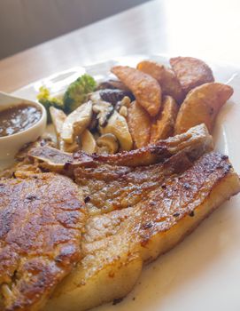 Pork steak with vegetables and french fried