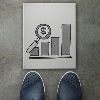 Hand drawn people business graph chart icon on canvas board on front of business man feet as concept 