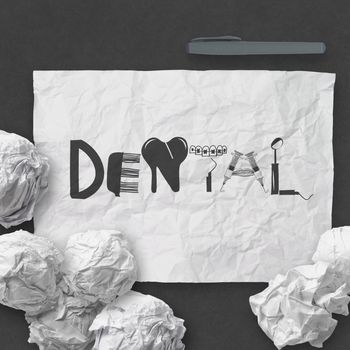 design word DENTAL on white crumpled paper and texture background as concept