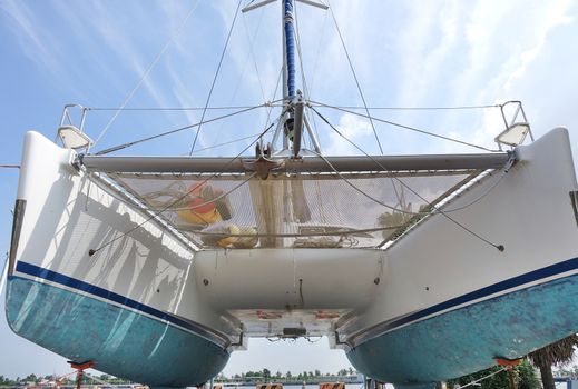 A large catamaran yacht with a double hull seen from below