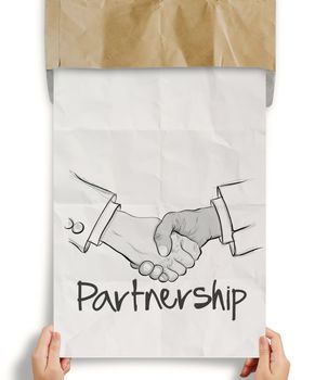 hand drawn handshake sign on crumpled paper as partnership business concept