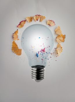 3d render light bulb with pencil saw dust on paper background as creative concept