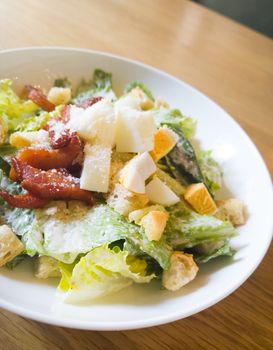  caesar salad placed on top of a wooden table