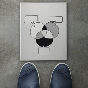 Hand drawn people business graph chart icon on canvas board on front of business man feet as concept 