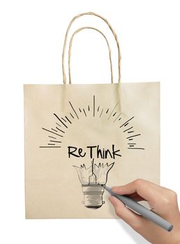 Hand drawn light bulb with RETHINK word paper recycle bag on white background as concept