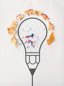 graphic pencil  light bulb with pencil saw dust on paper background as creative concept