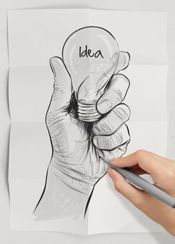 Hand drawn light bulb with IDEA word on crumpled paper as concept