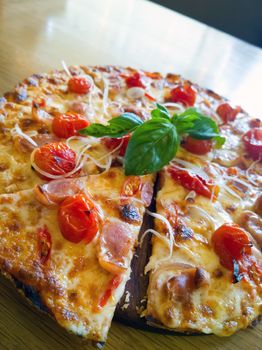 Pizza with ham, pepper and tomato