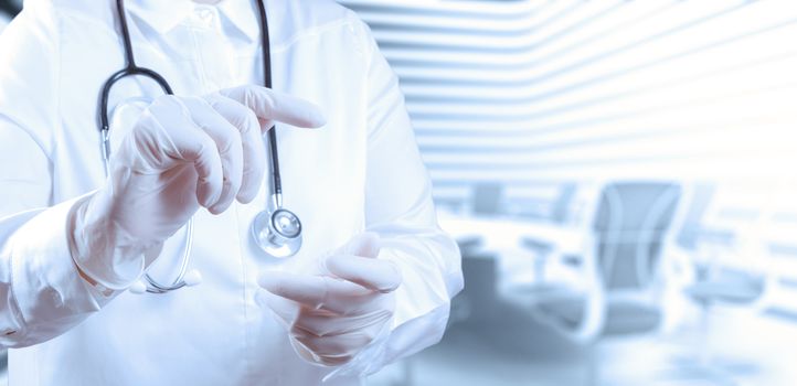 Doctor with a stethoscope in the hands and office background 