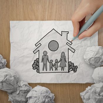 hand draw family and house on crumpled paper as insurance concept 