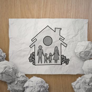 hand draw family and house on crumpled paper as insurance concept 