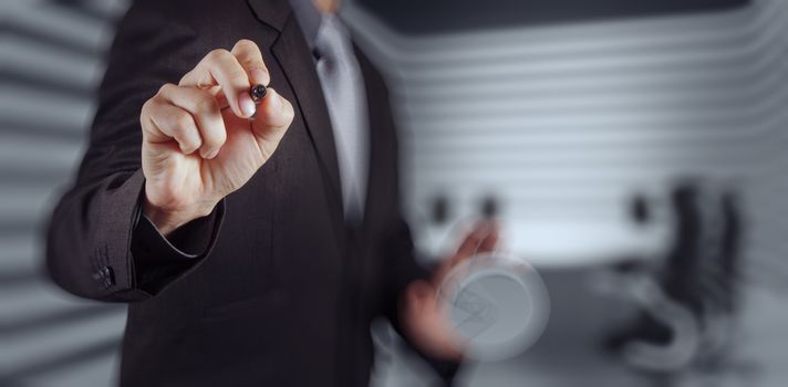 Businessman hand pressing an imaginary button on virtual screen