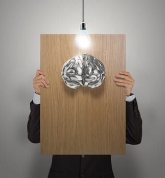 businessman hand show wooden poster of 3d metal brain as concept 