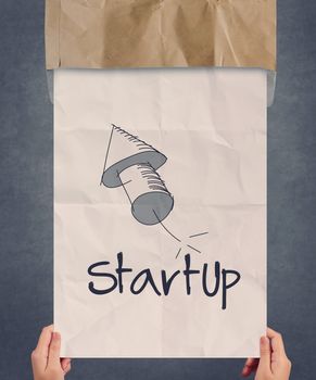 businessman hand showing poster of start up icon as concept 