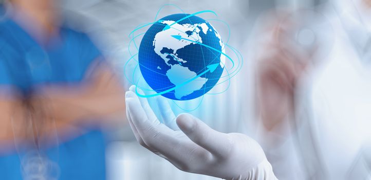 Medical Doctor holding a world globe in her hands as medical network concept 