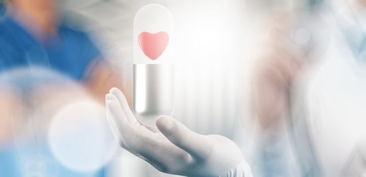 medical hand with glove heart inside capsule pill as concept 