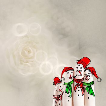 A lovely family hand drawn and finger of snowmen on flowers nature background as concept idea 