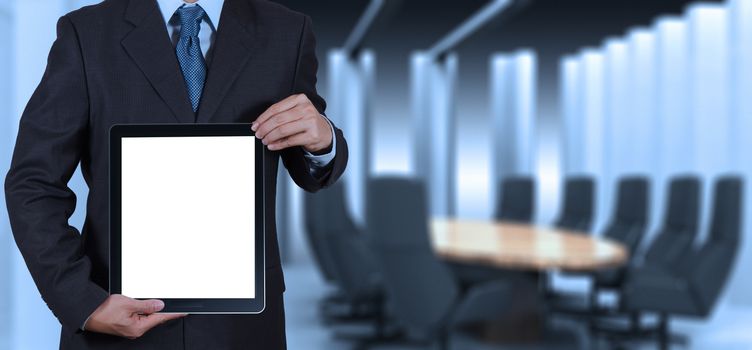 businessman success working with blank tablet computer his board room background as concept