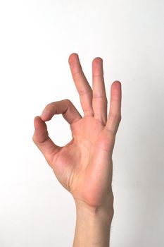 White male hand making the "OK" sign. Approval, satisfaction concept.