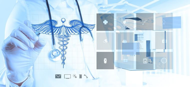 doctor hand draws Caduceus on the new computer interface