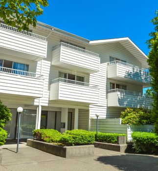 Low-rise apartment building in suburb of Vancouver, Canada. Apartment building on a sunny day with blue sky background