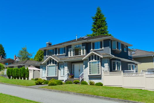 Big family house in suburbs of Vancouver on blue sky background
