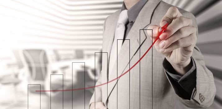 businessman hand draws business success chart concept on virtual screen