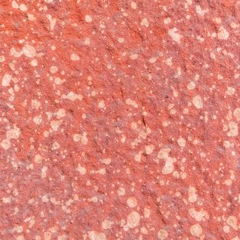 Red rough stone texture background. Material construction and architectural detail.