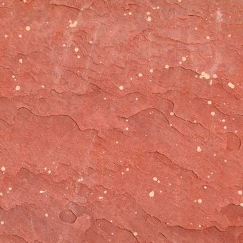 Red rough stone texture background. Material construction and architectural detail.