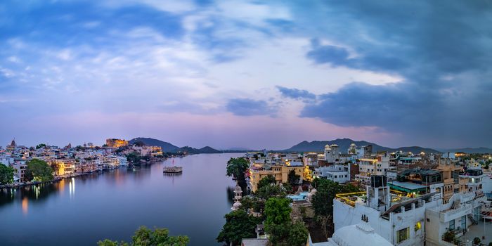 Udaipur city at lake Pichola in the evening, Rajasthan, India. View of City palace reflected on the lake.