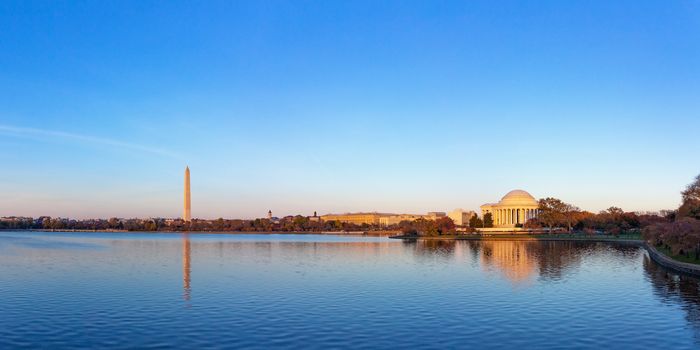 Jeffeerson Memorial and Washington Monument reflected on Tidal Basin in the evening, Washington DC, USA. Panoramic image