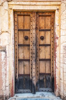 Antique rustic ancient wooden door. Architectural element.