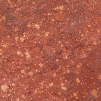 Red rough stone texture background. Material construction and architectural detail.