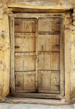 Antique rustic ancient wooden door. Architectural element.