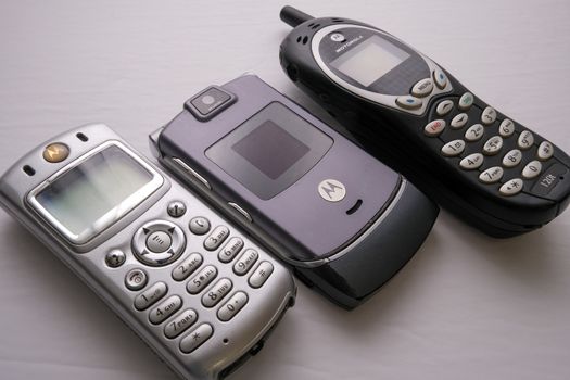 Three popular Motorola cell phones from the early 2000s: a Motorola C333, a Motorola Razr V3i, and a Motorola 120t.
