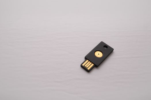 An isolated USB device containing a security key is used for two-factor authentication adding a layer of security to logins and authorization online.