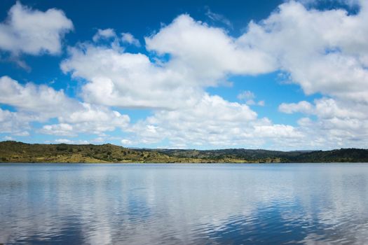 Cumulus clouds reflected on the waters of lake La Florida, in San Luis, Argentina.