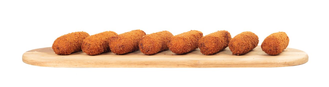 Brown crusty dutch kroketten on a serving tray, isolated on a white background