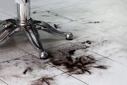 hair on floor in barber shop, barbers, haircut clipping, hair scrap, pile of hair dirty waste, cut hair on the floor in a hairdressing salon