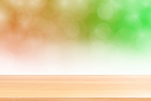 empty wood table floors on blurred bokeh soft green gradient background, wooden plank empty on green bokeh colorful light shade, colorful bokeh lights gradient soft for banner advertising products