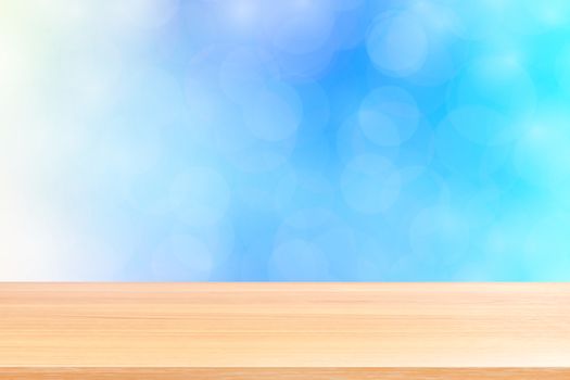 empty wood table floor on blurred bokeh soft blue gradient background, wooden plank empty on blue bokeh colorful light shade, colorful bokeh lights gradient blue soft for banner advertising products