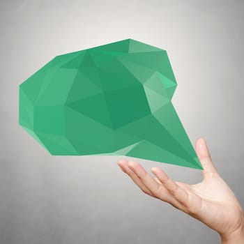 hand showing low poly geometric speech bubble on white background