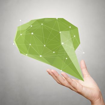 hand showing low poly geometric speech bubble with social media structure on white background