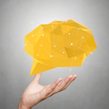 hand showing low poly geometric speech bubble with social media structure on white background