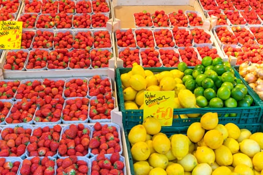 Strawberries, lemons and limes for sale at a market