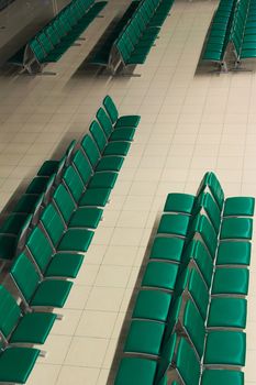 Green empty seats at an airport waiting area. High angle view.