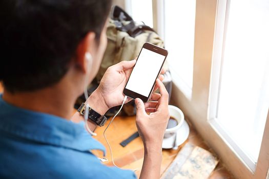 Cropped shot view of man hands holding smart phone with blank copy space screen for your text message or information content, female reading text message on cell telephone during in urban setting. 