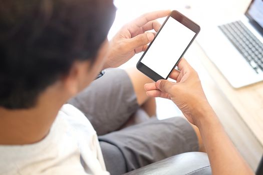 Cropped shot view of man hands holding smart phone with blank copy space screen for your text message or information content, female reading text message on cell telephone during in urban setting.