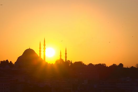 Hagia Sophia, the most important tourist attraction of Istanbul, Turkey, silhouetted against the bright sunset sky.