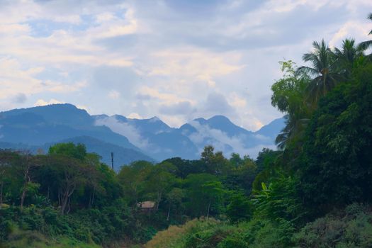 Misty mountains over the jungle in Luang Prabang, Laos.